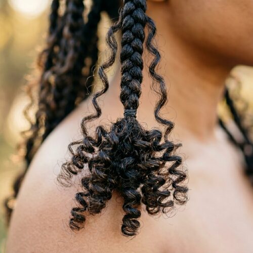 Black woman with boho braids with curly ends — step by step boho braid tutorial result